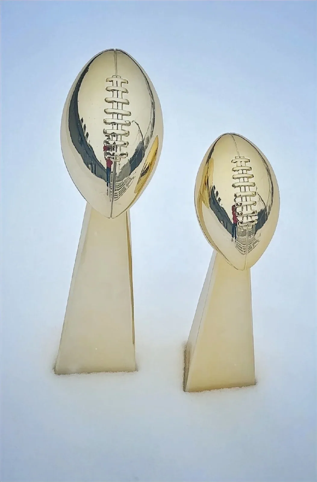 Gold and silver fantasy football Lombardi trophies